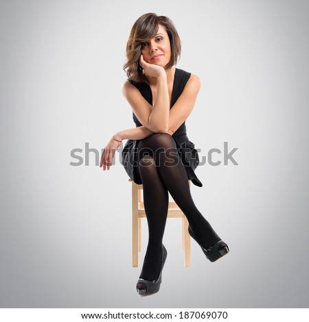 Pretty brunette woman isolated over grey background 