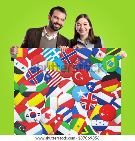 Couple holding placard over green background 