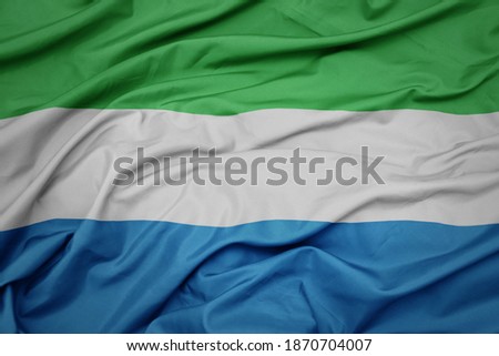 waving colorful national flag of sierra leone. macro shot