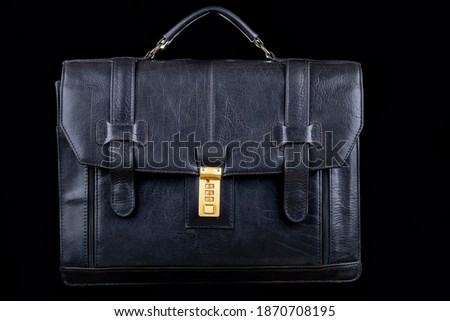 Studio lighting. dark background. Black briefcase in retro style. Close-up