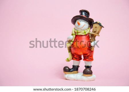 Christmas card with place for text. snowman in a red suit and a yellow scarf.