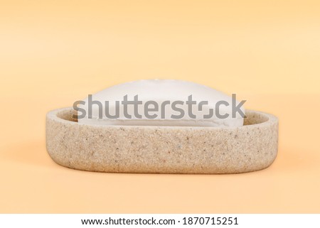 Soap in a soap dish close up. Side view isolated on beige, clipping path included Royalty-Free Stock Photo #1870715251