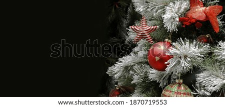 Decorated Christmas tree on a dark background