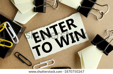 enter to win. word. text. on white paper on craft background on wood table