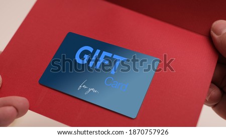 Opening a Christmas Greeting Card with a Gift Card inside