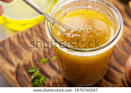 Homemade vinaigrette salad dressing with olive oil, vinegar and herbs Royalty-Free Stock Photo #1870760287
