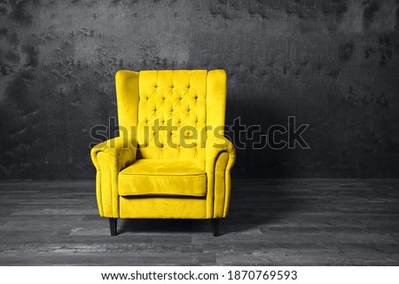 Yellow armchair over grey background. Trendy colors 2021 year. Royalty-Free Stock Photo #1870769593