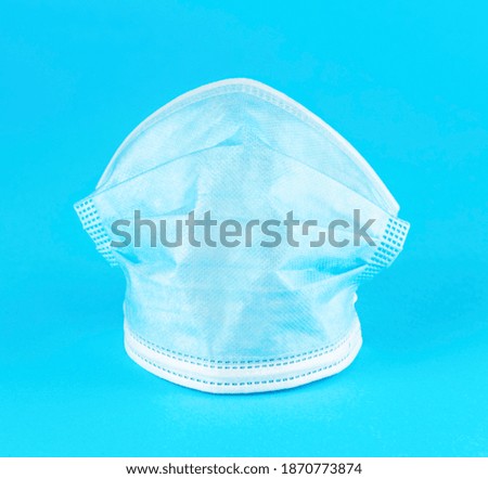 
Protective medical three-layer mask on a blue background.