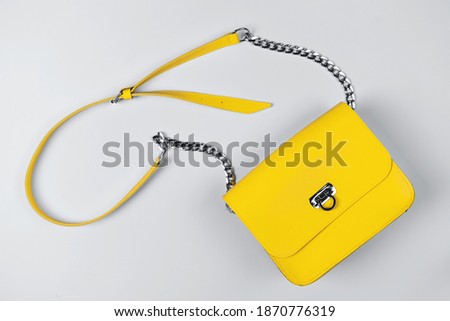 Demonstrating trendy colors 2021 - Gray and Yellow. Fashionable leather bag