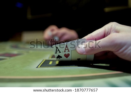 Casino interior. Card game of poker. Texas hold'em poker. The combination is a pair of aces for the player. Big win. Royalty-Free Stock Photo #1870777657
