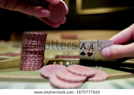 Casino interior. Card game of poker. Texas hold'em poker. The combination is a pair of aces for the player. Big win.