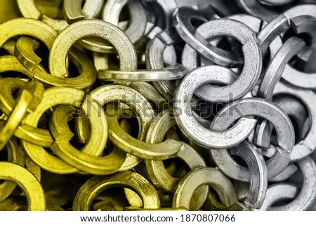 Abstract background of many metal rings close-up. Trend colors of the year 2021