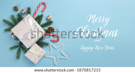 A Christmas card. Boxes with gifts of Christmas decorations on a blue background. Horizontal Christmas card
