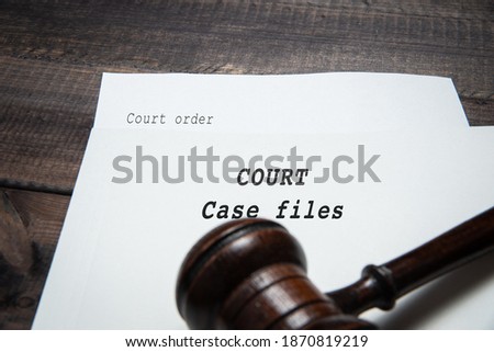 Judge's gavel with a file. Briefcase with the word Court. The concept of recognizing court cases, conducting court proceedings.