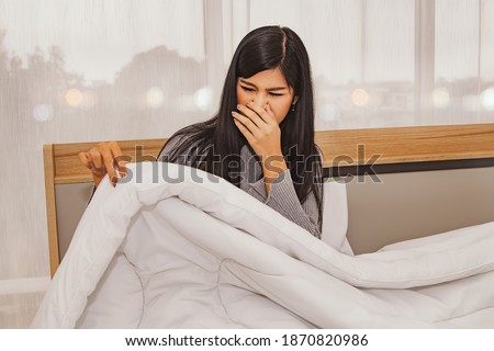 Concept respiratory health care and allergies : Woman had a stinging nose from a dirty blanket in her bedroom. Royalty-Free Stock Photo #1870820986
