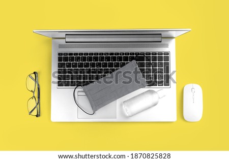 Color of the year 2021. Office computer gadget on Ultimate Gray and Illuminating yellow background. Hygiene banner with protective medical mask, sanitizer. Virus protection stay home remote work
