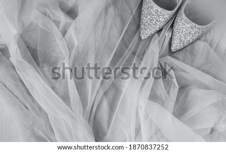 shining silver shoes on Ultimate Gray tulle fabric, festive mock up in color of year 2021, selective focus