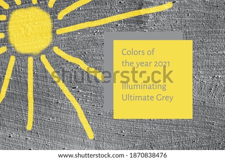 Background grey smooth concrete wall with painted yellow sun. Colors of year 2021.