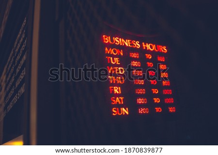 red and green open neon sign with business hhours