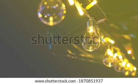 Retro style incandescent light bulb. Colors of the year 2021- yellow and ultimate gray background.