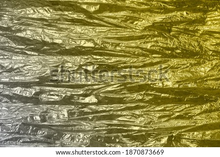 Holographic abstract yellow gray textured background. Color trend 2021.