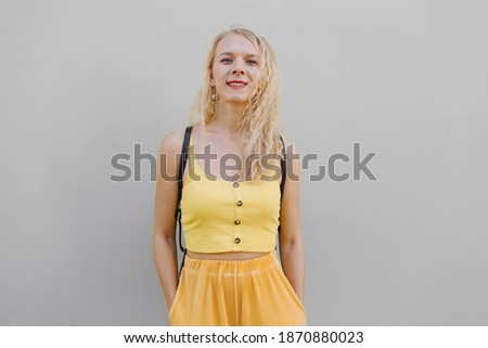 Portrait of a beautiful young woman on gray background