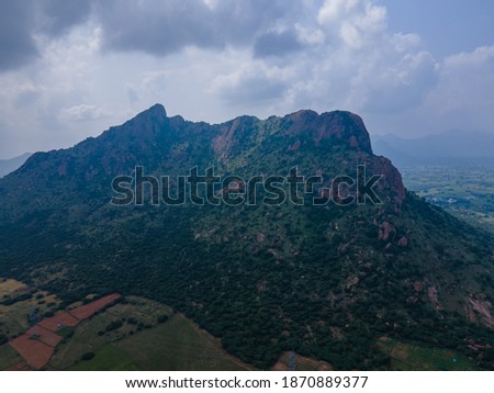 Drone shot aerial view top angle photo of mountain agricultural fields cloudy day hills wallpaper background india tamilnadu scenic 