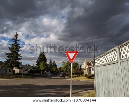 Yield Sign against a backdrop of dark clouds