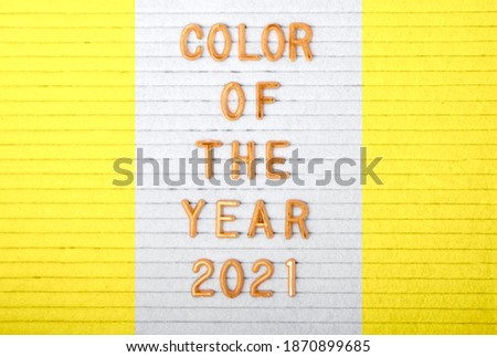Close up golden letters on the letter box.Painted in trendy 2021 colors - grey and yellow.Creative layout.
