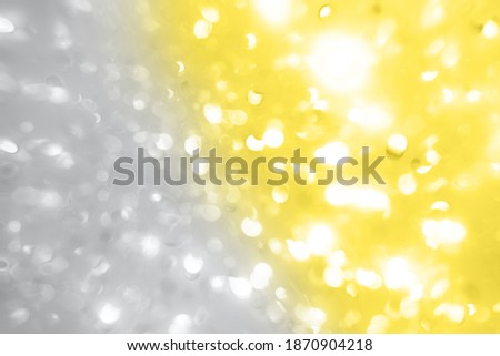 Bright Colorful bokeh light on Ultimate Gray and Illuminating yellow background. Color of the year 2021. Blurry holographic. Holiday wallpaper party glowing. Bright defocused Abstract glittery clipart