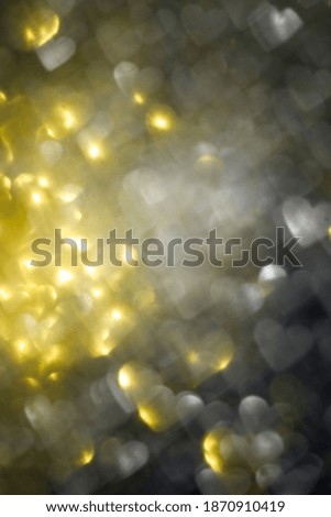 Valentines Day romantic heart shape blurred bokeh lights background toned trendy colors illuminating and ultimate gray