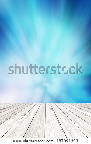 Wood board on shiny abstract blue background