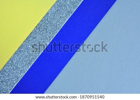 Geometric color block paper background with empty space. Abstract geometric background with 3 multicolored sectors, gray, blue and bright yellow 