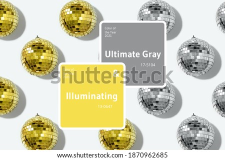 Demonstrating trendy Color of the Year 2021. Illuminating Yellow and Ultimate Gray. Yellow mirror disco balls pattern on yellow background. Minimal New year party concept. Christmas greeting card.