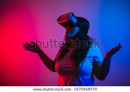 Gamer girl using vr glasses to play videogames. Woman playing videogames with virtual reality technology 