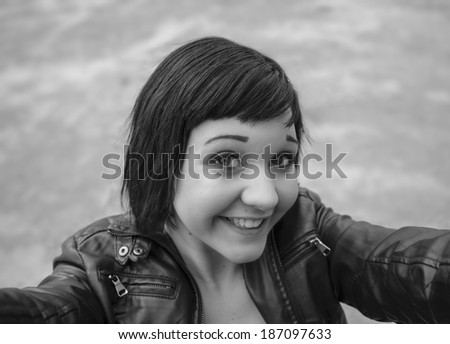 Girl taking a selfie in black and white