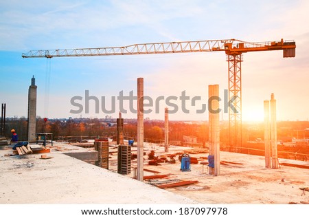 tower crane at construction site in morning sunlight