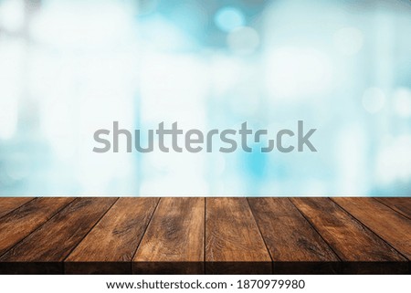 Empty top of wood table with blur interior kitchen or cafe for background.