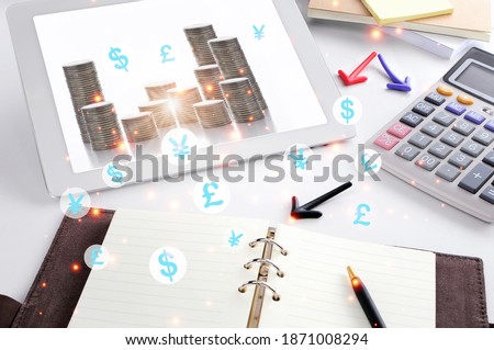 Return on investment concept and financial technology idea. Stack of coin and currency symbol on computer tablet screen on working desk background