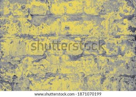 Old brick wall in yellow and gray colors. Textured background.
