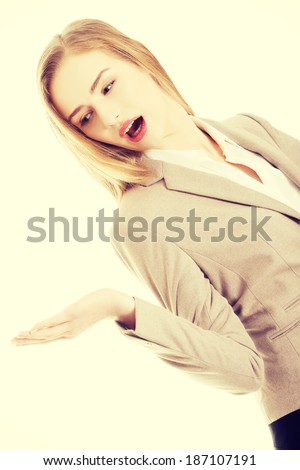 Happy business woman showing copy space on her palm