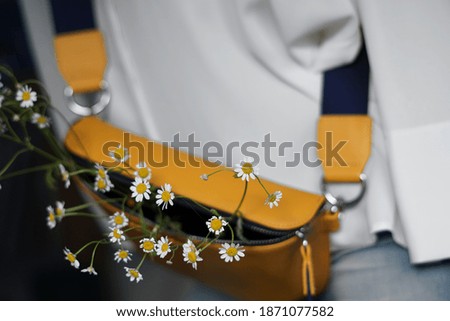 Stylish yellow bag with chamomile. Trendy colors 2021.