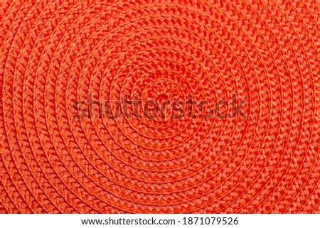 Red wicker table mat in a close up view