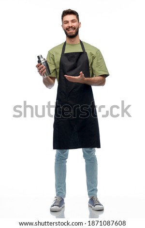 alcohol drinks, people and job concept - happy smiling barman in black apron with shaker preparing cocktail over white background Royalty-Free Stock Photo #1871087608