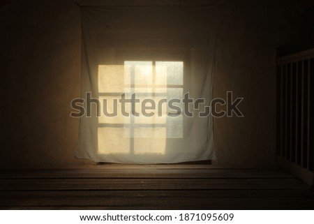 Projection. The early morning sun peaking through the window in a farm in France.