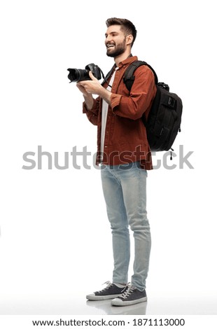 photography, travel and people and concept - happy smiling man or photographer with digital camera and backpack over white background