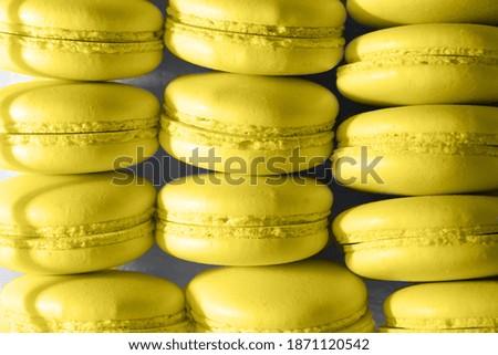 Yellow macaroons on a gray background. Colors of 2021.