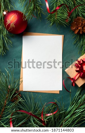 Christmas mockup, greeting card with gift box and christmas decorations, pine tree branches on green background