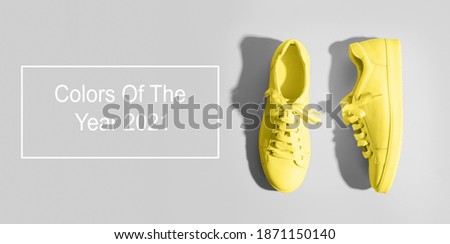 Banner with yellow female gumshoes on grey background. View from above. Space for text.
