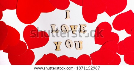 I LOVE YOU written on a light background surrounded by red hearts. Valentine's Day. Romantic concept